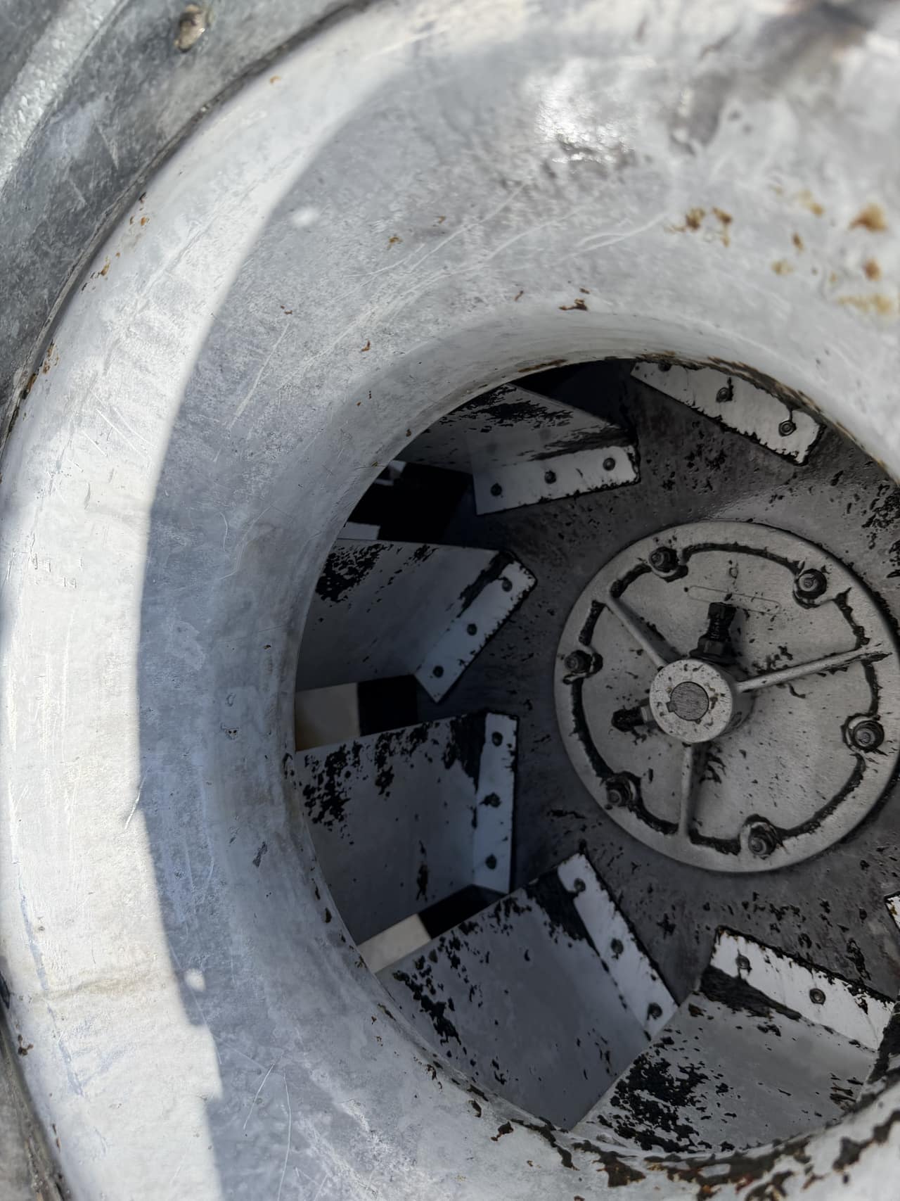 The same rooftop exhaust fan housing and blades after grease removal and cleaning.