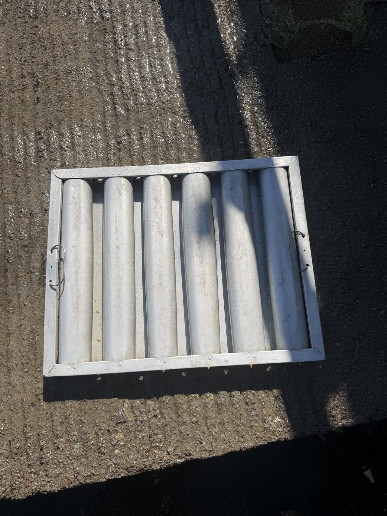 Metal baffle filters staged on the roof during a full restaurant kitchen-exhaust cleaning.
